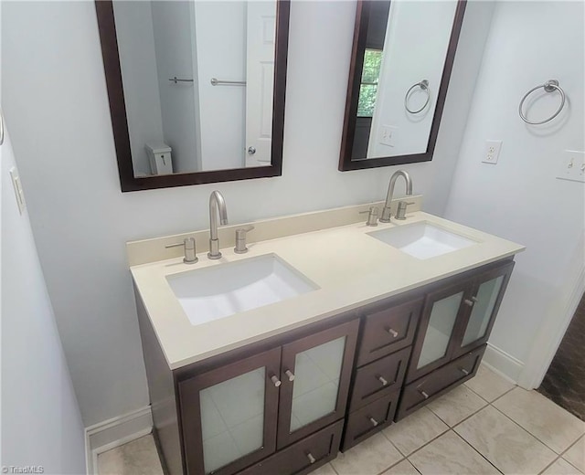 bathroom with tile patterned floors and double vanity