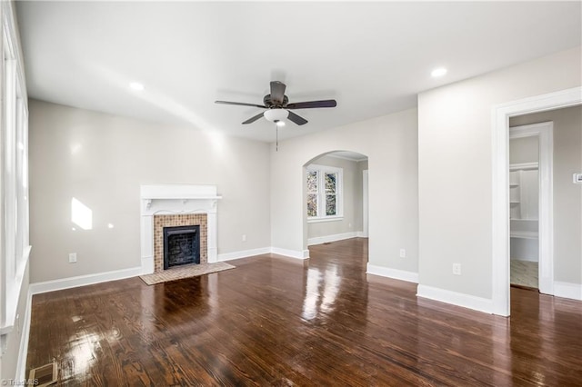 unfurnished living room featuring dark hardwood / wood-style flooring and ceiling fan