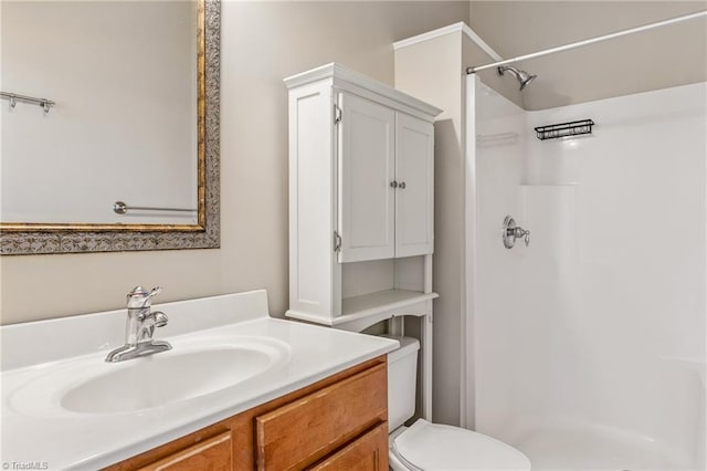 full bath featuring vanity, a shower stall, and toilet