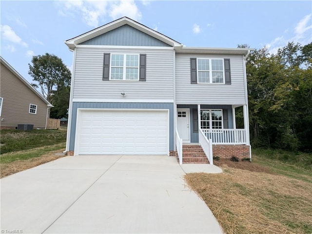 view of front of home featuring cooling unit, covered porch, concrete driveway, and an attached garage