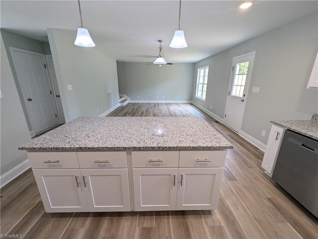 kitchen with dishwasher, white cabinets, and decorative light fixtures