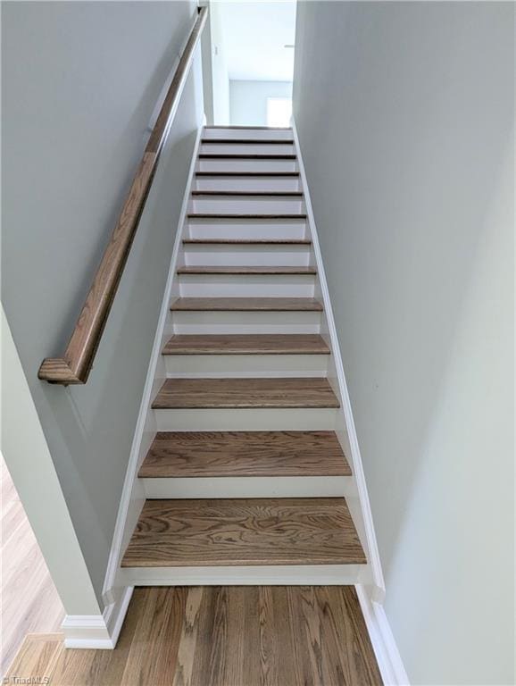 stairway featuring wood finished floors