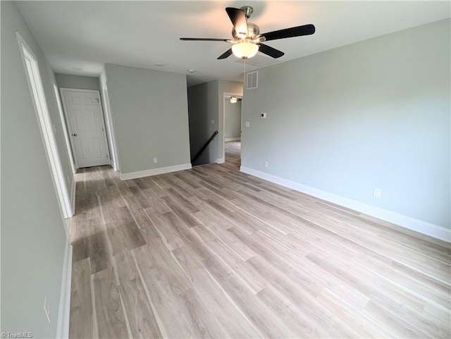 empty room with ceiling fan and light hardwood / wood-style flooring