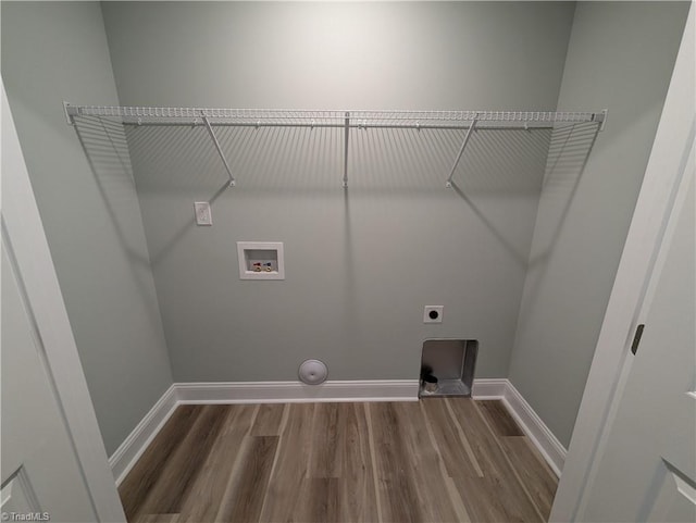 laundry area featuring baseboards, wood finished floors, hookup for an electric dryer, and hookup for a washing machine