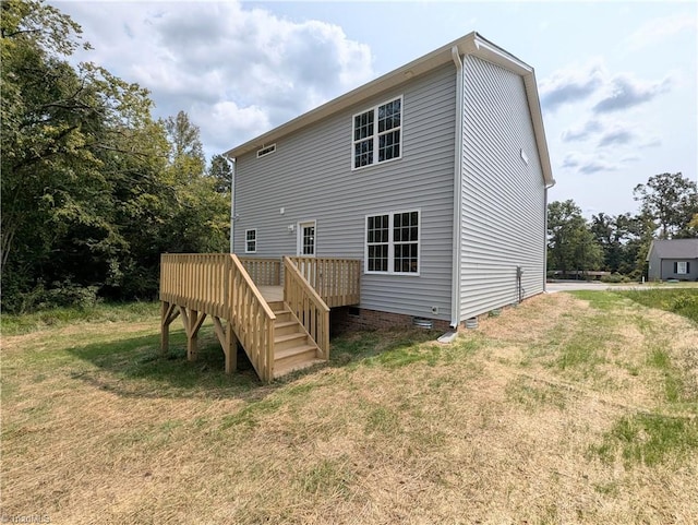 rear view of house with crawl space, a yard, and a deck