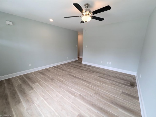 empty room with ceiling fan and light wood-type flooring