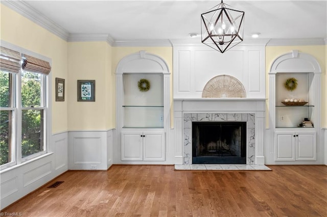 1420 Thornhill Ln, Winston-Salem, NC 27106 - unfurnished living room with a chandelier, wood finished floors, ornamental molding, wainscoting, and a fireplace