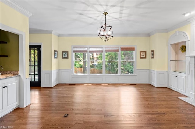 1420 Thornhill Ln, Winston-Salem, NC 27106 - unfurnished dining area featuring wood finished floors, ornamental molding, a wainscoted wall, a chandelier, and a decorative wall