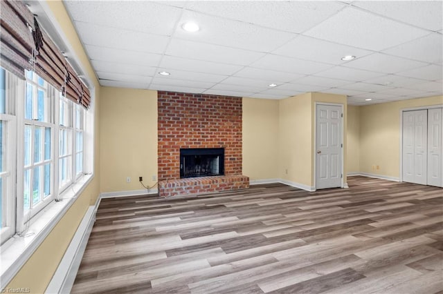 1420 Thornhill Ln, Winston-Salem, NC 27106 - unfurnished living room featuring wood finished floors, a paneled ceiling, a fireplace, and recessed lighting