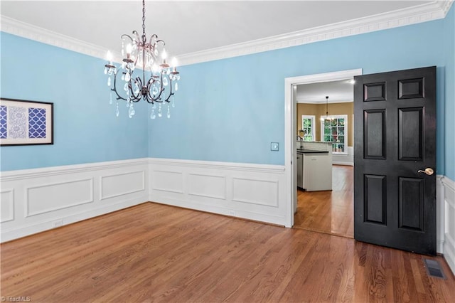 1420 Thornhill Ln, Winston-Salem, NC 27106 - unfurnished dining area with a chandelier, ornamental molding, wood finished floors, and a wainscoted wall