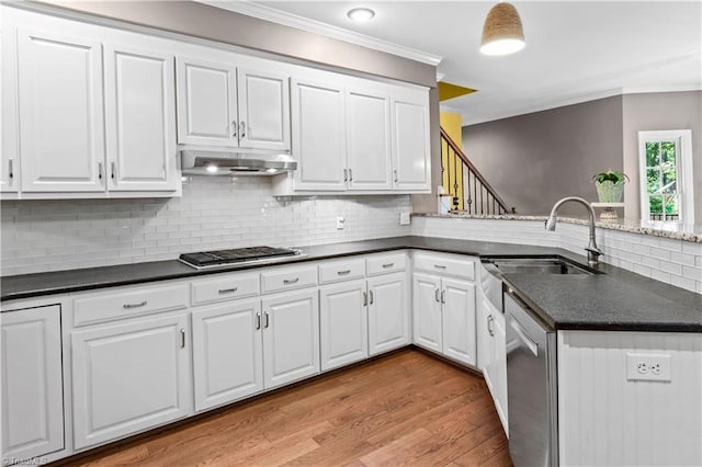 1420 Thornhill Ln, Winston-Salem, NC 27106 - kitchen featuring cooktop, under cabinet range hood, dishwasher, crown molding, and dark countertops