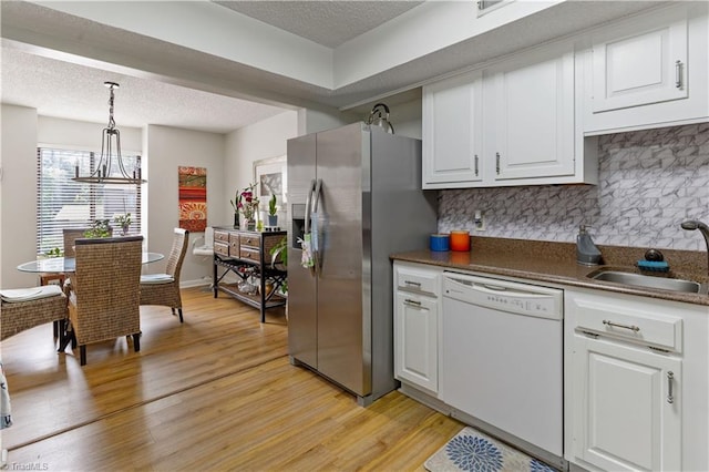 2429 Cypress Ct, High Point, NC 27265 - kitchen with white dishwasher, stainless steel fridge with ice dispenser, light wood-type flooring, tasteful backsplash, and white cabinetry
