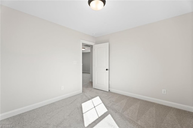 unfurnished bedroom featuring baseboards and carpet