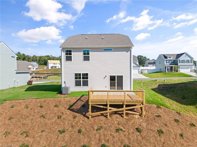 back of property with a lawn, a residential view, cooling unit, and a deck