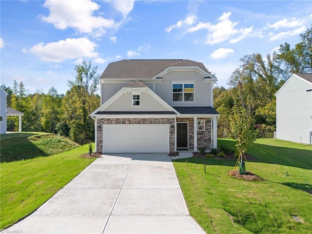 craftsman inspired home featuring a front lawn, driveway, stone siding, and an attached garage