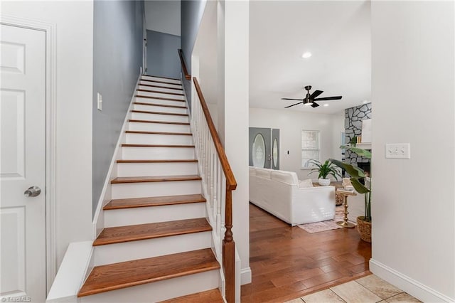 4636 Shattalon Cir, Winston-Salem, NC 27106 - staircase featuring a ceiling fan, baseboards, recessed lighting, a fireplace, and wood finished floors