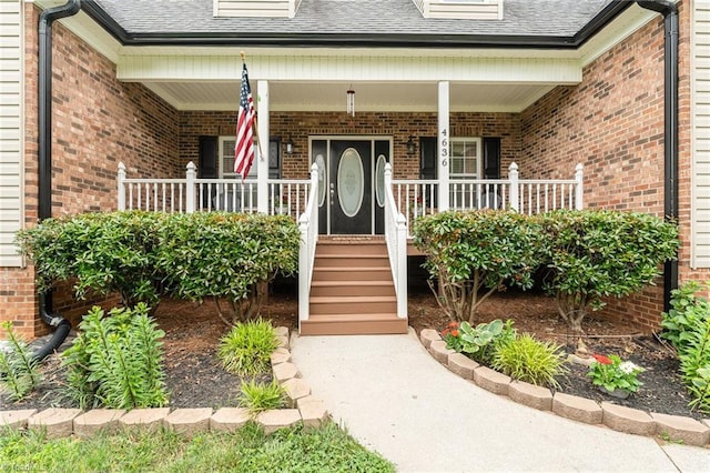 4636 Shattalon Cir, Winston-Salem, NC 27106 - doorway to property featuring a shingled roof, covered porch, and brick siding