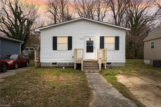 bungalow-style house with central air condition unit and crawl space