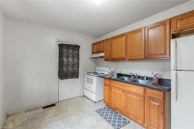 kitchen featuring dark countertops, brown cabinets, white appliances, and a sink