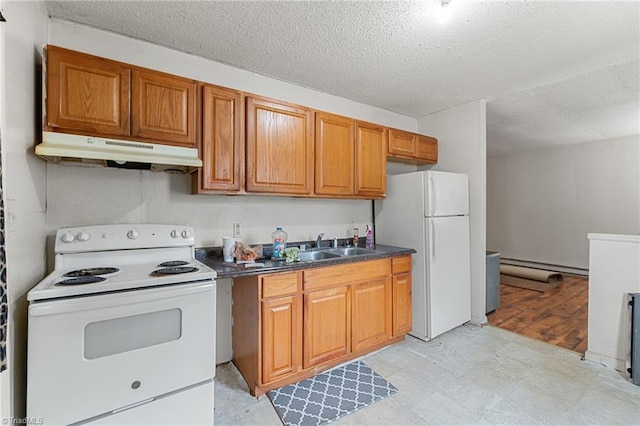 kitchen featuring white appliances, light floors, brown cabinets, and under cabinet range hood