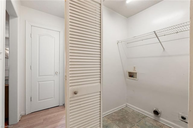 laundry area featuring laundry area, hookup for a washing machine, hookup for an electric dryer, and baseboards