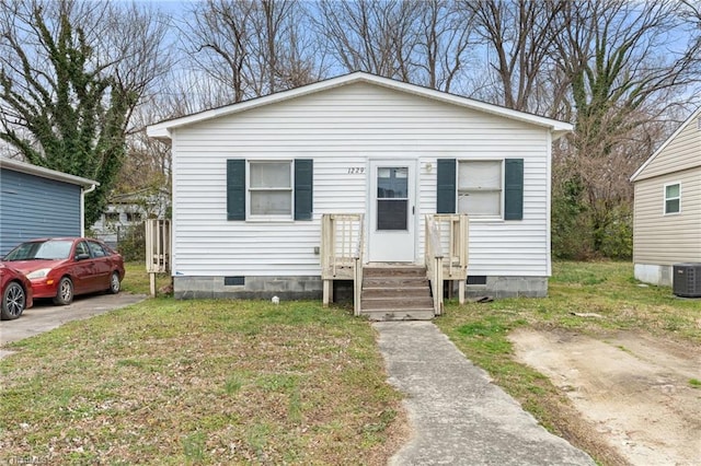 bungalow-style house featuring a front yard, central AC unit, and crawl space