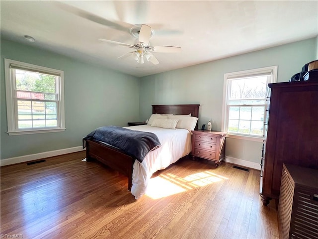 bedroom with ceiling fan and light hardwood / wood-style floors