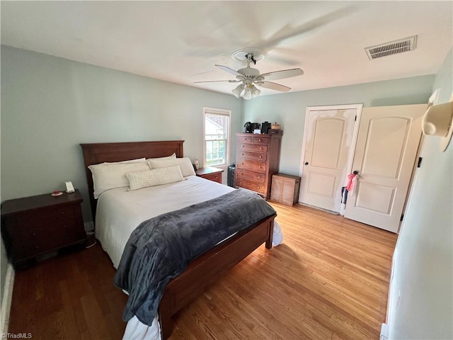 bedroom with ceiling fan and light wood-type flooring