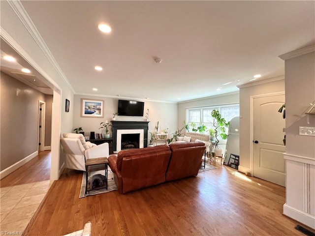 living room featuring crown molding and light wood-type flooring