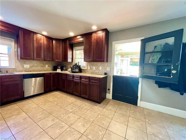 kitchen with dishwasher, plenty of natural light, light tile patterned flooring, and decorative backsplash