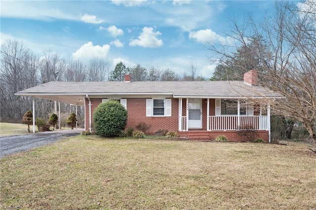 single story home with a carport, covered porch, and a front lawn