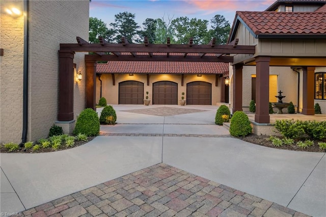 view of front of home featuring a pergola and a garage