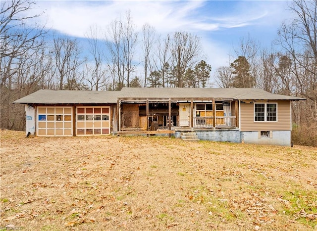 ranch-style house featuring a porch and a garage