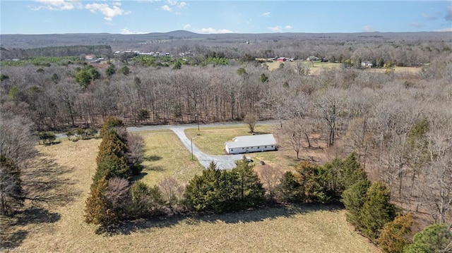 birds eye view of property with a forest view