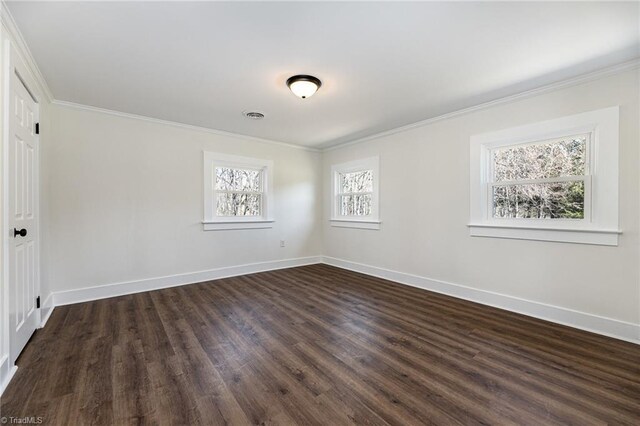 unfurnished room featuring crown molding, baseboards, and visible vents