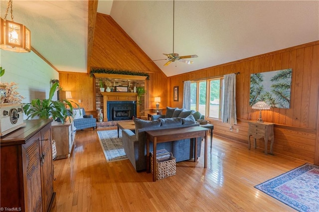 1160 Flinty Knoll Rd, Pinnacle, NC 27043 - living area featuring wooden walls, ceiling fan, light wood-type flooring, a fireplace, and high vaulted ceiling