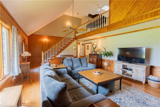 1160 Flinty Knoll Rd, Pinnacle, NC 27043 - living room featuring wooden walls, stairway, wood finished floors, high vaulted ceiling, and a ceiling fan