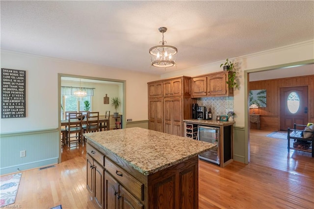 1160 Flinty Knoll Rd, Pinnacle, NC 27043 - kitchen featuring a chandelier, beverage cooler, plenty of natural light, ornamental molding, and a textured ceiling