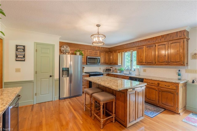 1160 Flinty Knoll Rd, Pinnacle, NC 27043 - kitchen with stainless steel appliances, a sink, a chandelier, brown cabinets, and crown molding