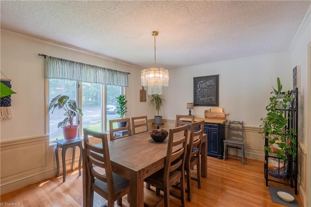 1160 Flinty Knoll Rd, Pinnacle, NC 27043 - dining space with crown molding, a chandelier, light wood-type flooring, a textured ceiling, and wainscoting