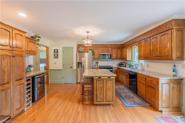 1160 Flinty Knoll Rd, Pinnacle, NC 27043 - kitchen featuring stainless steel appliances, brown cabinetry, a kitchen breakfast bar, a sink, and light wood-type flooring