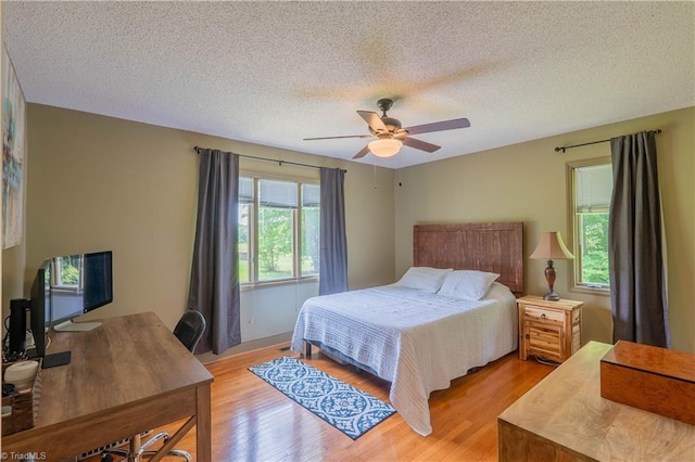 1160 Flinty Knoll Rd, Pinnacle, NC 27043 - bedroom with light wood-type flooring, ceiling fan, and a textured ceiling
