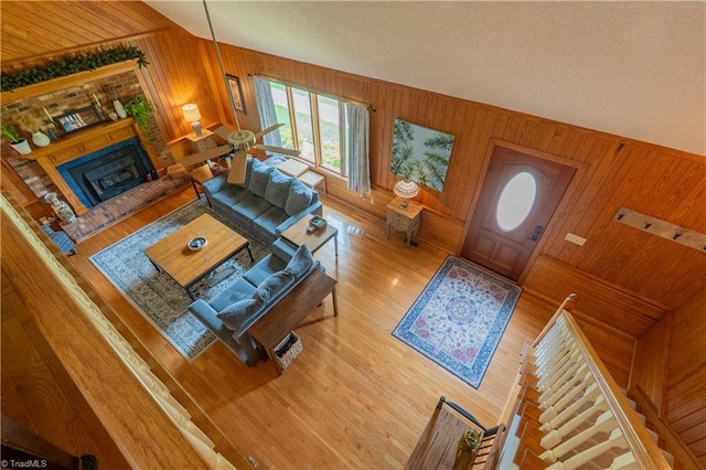 1160 Flinty Knoll Rd, Pinnacle, NC 27043 - living area with wood walls, wood finished floors, and a brick fireplace