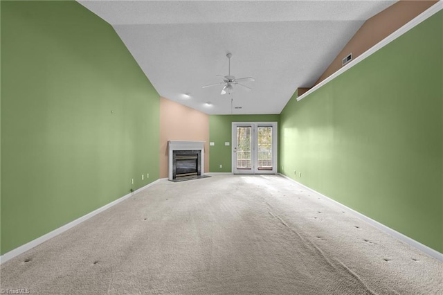 3027 Maple Ave Unit M2, Burlington, NC 27215 - unfurnished living room featuring vaulted ceiling, a fireplace with flush hearth, a ceiling fan, carpet flooring, and baseboards