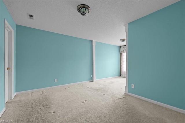 3027 Maple Ave Unit M2, Burlington, NC 27215 - carpeted spare room with a textured ceiling and baseboards