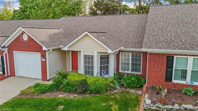 3027 Maple Ave Unit M2, Burlington, NC 27215 - view of front of house featuring brick siding, an attached garage, a shingled roof, and concrete driveway