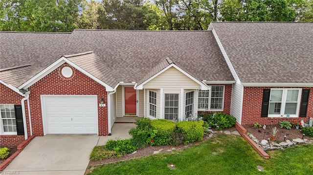3027 Maple Ave Unit M2, Burlington, NC 27215 - view of front of property with brick siding, a garage, a shingled roof, and driveway