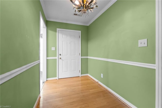 3027 Maple Ave Unit M2, Burlington, NC 27215 - doorway to outside with a chandelier, light wood-style flooring, baseboards, and crown molding