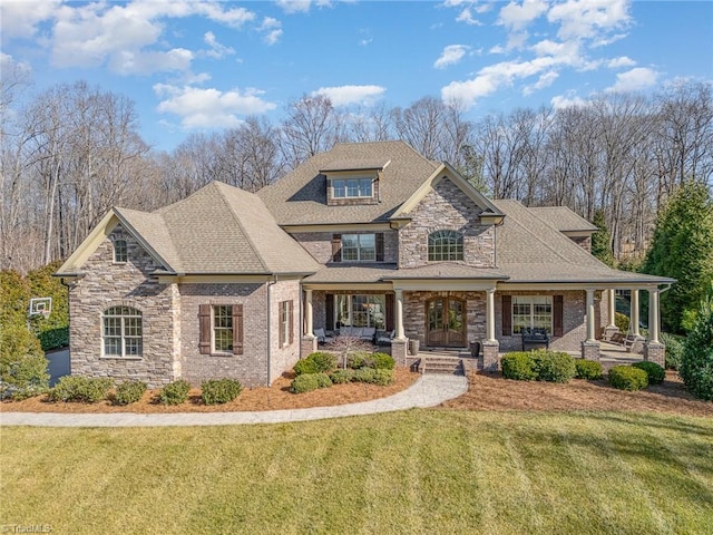 craftsman house with a front lawn and a porch