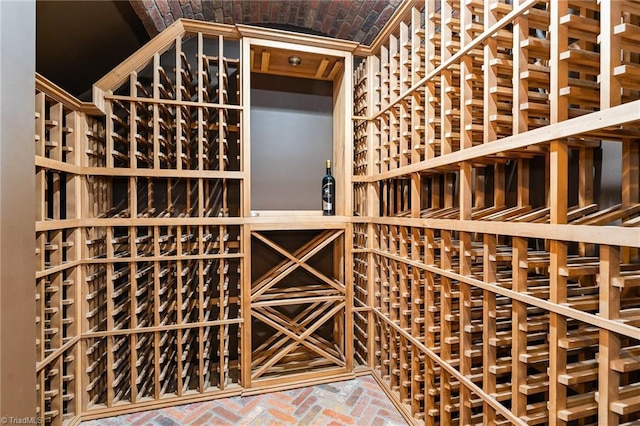 wine area featuring brick ceiling